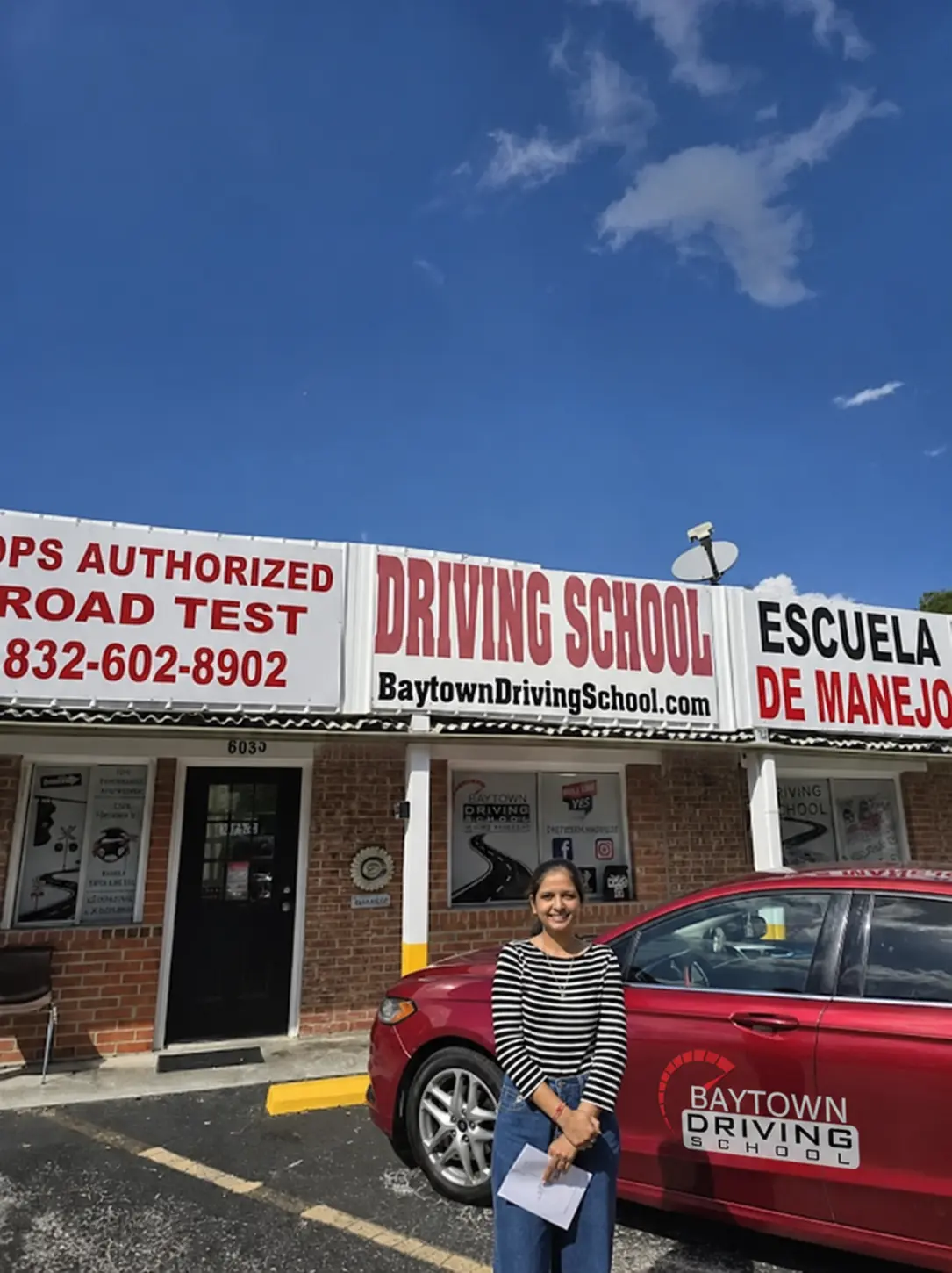 Road test customer beside a Baytown Driving School vehicle